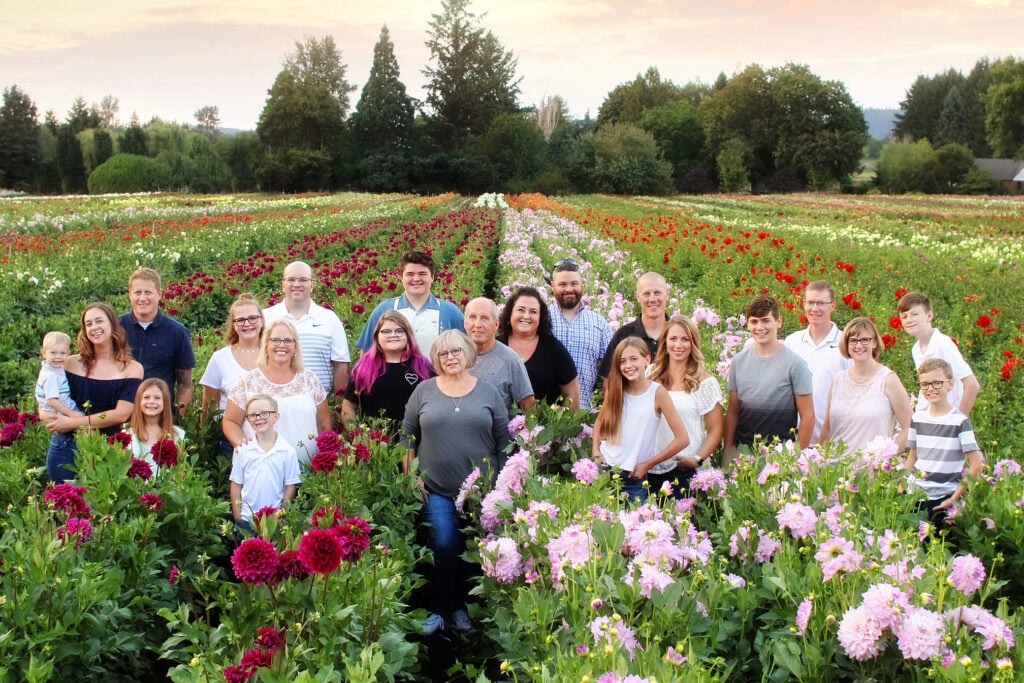 The Gitts Family, the owners of Swan Island Dahlia's, standing in a field of Dahlias.