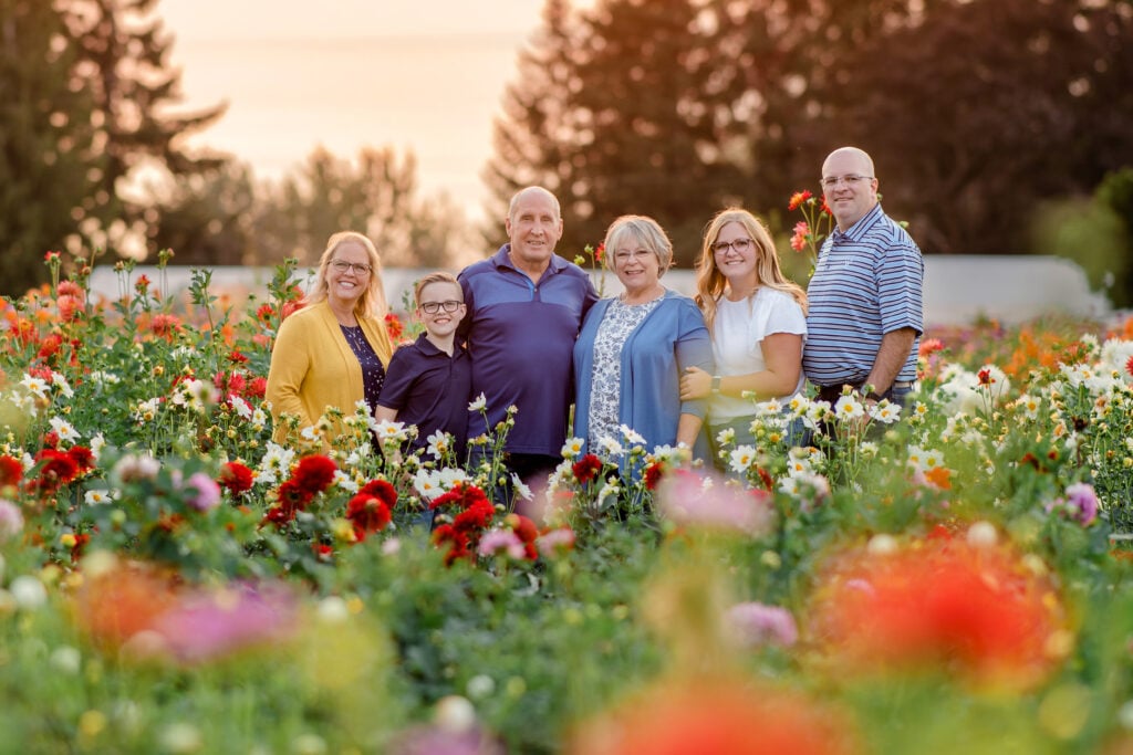 The Gitts Family, the owners of Swan Island Dahlia's, standing in a field of Dahlias.