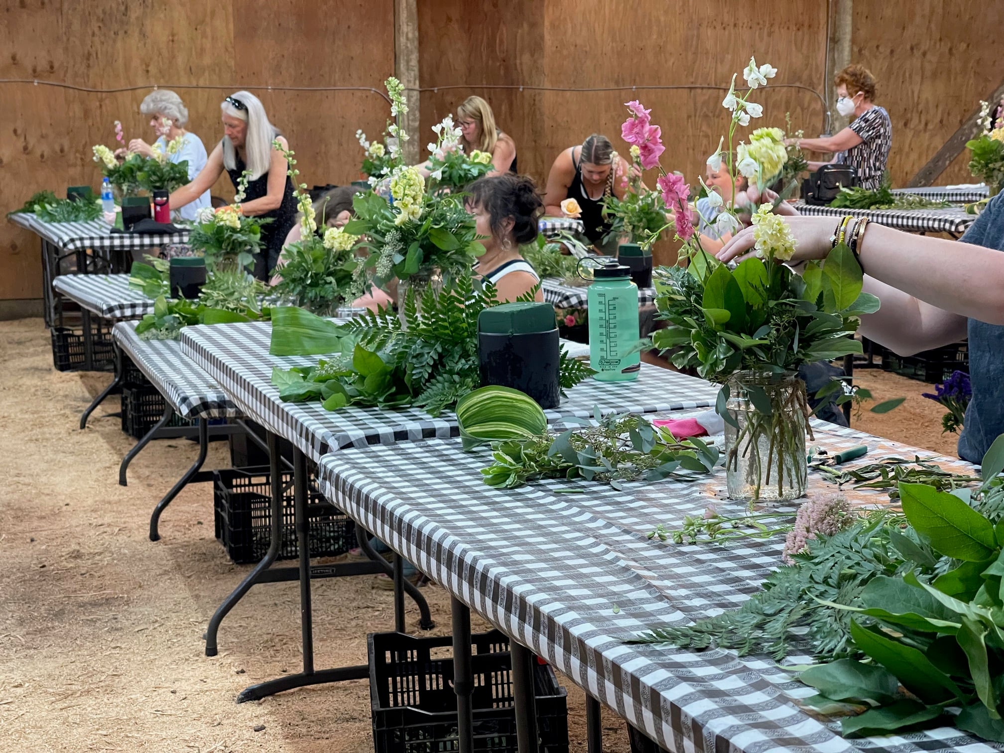 Blank canvases are set up on long tables in anticipation of an art class